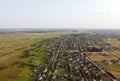 Aerial view of small village in Ukraine. Above view of rural area houses, cultivated fields and parcels, country roads