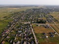 Aerial view of small village in Ukraine. Above view of rural area houses, cultivated fields and parcels, country roads