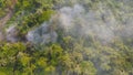 Aerial view of smoke from fire burning in the forest with green trees in Bangkok City, Thailand. Nature landscape background in Royalty Free Stock Photo