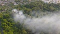 Aerial view of smoke from fire burning in the forest with green trees in Bangkok City, Thailand. Nature landscape background in Royalty Free Stock Photo