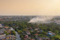 Aerial view of smoke from fire burning in the forest with green trees in Bangkok City, Thailand. Nature landscape background in Royalty Free Stock Photo