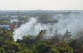 Aerial view of smoke from fire burning in the forest with green trees in Bangkok City, Thailand. Nature landscape background in Royalty Free Stock Photo