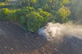 Aerial view of smoke from fire burning in the forest with green trees in Bangkok City, Thailand. Nature landscape background in Royalty Free Stock Photo