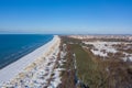 Aerial view of snow covered city of Liepaja next to beach and dunes and blue calm sea Royalty Free Stock Photo