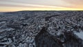 Aerial view of snow covered cityscape Hamaroy surrounded by buildings during sunset