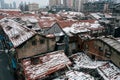 Aerial view of snow-covered roofs of old city buildings before the modern towers Royalty Free Stock Photo