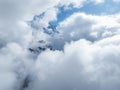 Aerial View of Snow Covered Swiss Alps Peaks Through Clouds near Verbier