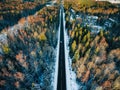 Aerial view of snow covered trees in forest and winter country road with a car Royalty Free Stock Photo