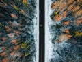 Aerial view of snow covered trees in forest and winter country road with a car Royalty Free Stock Photo