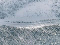 Aerial view of snow covered winter forest and road. Beautiful rural landscape in Finland Royalty Free Stock Photo