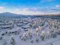 Aerial view of snow covered winter forest and road. Beautiful rural landscape in Finland Royalty Free Stock Photo