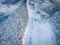 Aerial view of snow covered winter forest and road. Beautiful rural landscape in Finland Royalty Free Stock Photo