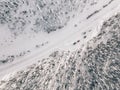 Aerial view of snow covered winter forest and road. Beautiful rural landscape in Finland Royalty Free Stock Photo