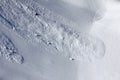 Aerial view of snow slope with trace of avalanche and ski track