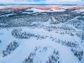 Aerial view of snow winter landscape with mountains, snow covered forests, frozen lakes and winter roads in Finland Royalty Free Stock Photo