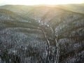 Aerial view of snowy forest with road. winter landscape Royalty Free Stock Photo