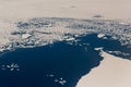 Aerial view of the snowy ice-covered landmass in Antarctica