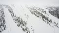 Aerial view of a snowy mountain landscape with a ski lift in Yllas, Finland