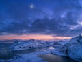 Aerial view of snowy mountains, sea, colorful cloudy sky at night Royalty Free Stock Photo