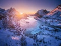 Aerial view of snowy mountains, sea, purple sky at sunset Royalty Free Stock Photo