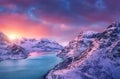 Aerial view of snowy mountains, sea, road, sky with pink clouds Royalty Free Stock Photo