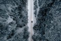 Aerial view of snowy road with cars, winter forest Royalty Free Stock Photo