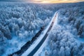 Aerial view of snowy winter forest in sunny day and straight road in the middle going forward Generative AI Royalty Free Stock Photo