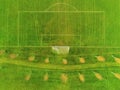 Aerial view soccer football pitch with goal post and trees and walking path behind.