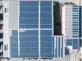 Aerial View of Solar Panel on Factory Rooftop, Solar energy electric panels creation on a storage building. Royalty Free Stock Photo