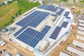 Aerial view of solar panels or solar cells on the roof of shopping mall building rooftop. Power plant, renewable clean energy