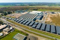 Aerial view of solar panels installed over parking lot with parked cars for effective generation of clean energy