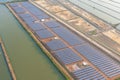 Aerial view of solar panels or solar cells on the roof in farm. Power plant with lake or river, renewable energy source in