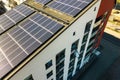 Aerial view of solar photovoltaic panels on a roof top of residential building block for producing clean electric energy. Royalty Free Stock Photo