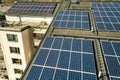 Aerial view of solar photovoltaic panels on a roof top of residential building block for producing clean electric energy. Royalty Free Stock Photo