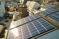 Aerial view of solar photovoltaic panels on a roof top of residential building block for producing clean electric energy. Royalty Free Stock Photo