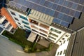 Aerial view of solar photovoltaic panels on a roof top of residential building block for producing clean electric energy. Royalty Free Stock Photo