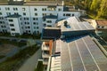 Aerial view of solar photovoltaic panels on a roof top of residential building block for producing clean electric energy. Royalty Free Stock Photo