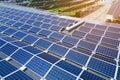 Aerial view of solar power plant with blue photovoltaic panels mounted on industrial building roof for producing green Royalty Free Stock Photo