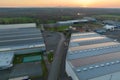 Aerial view of solar power plant with blue photovoltaic panels mounted on industrial building roof for producing green