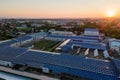 Aerial view of solar power plant with blue photovoltaic panels mounted on industrial building roof for producing green Royalty Free Stock Photo