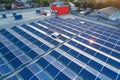 Aerial view of solar power plant with blue photovoltaic panels mounted on industrial building roof for producing green Royalty Free Stock Photo