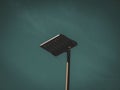 Aerial view of a solitary street lamp against a backdrop of a clear blue sky