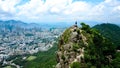 Aerial view on a solo travelling girl standing on my top of the rocky mountain Royalty Free Stock Photo