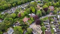 Aerial view of some large detached houses set amongst woodland