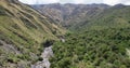 Aerial view of some mountains in peru, with a stream below.