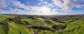 the aerial view of some roads through a wide grassy field