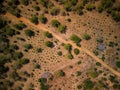 an aerial view of some trees, dirt, and grass