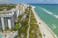 Aerial view of South Beach sandy surface with tourists relaxing on hot Florida sun. Miami Beach city with high luxury Royalty Free Stock Photo