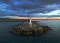 Aerial view of South Gare Lighthouse under dark cloudy sunset sky in England