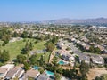 Aerial view of Southern California houses surrounded by golf in inland town Corona